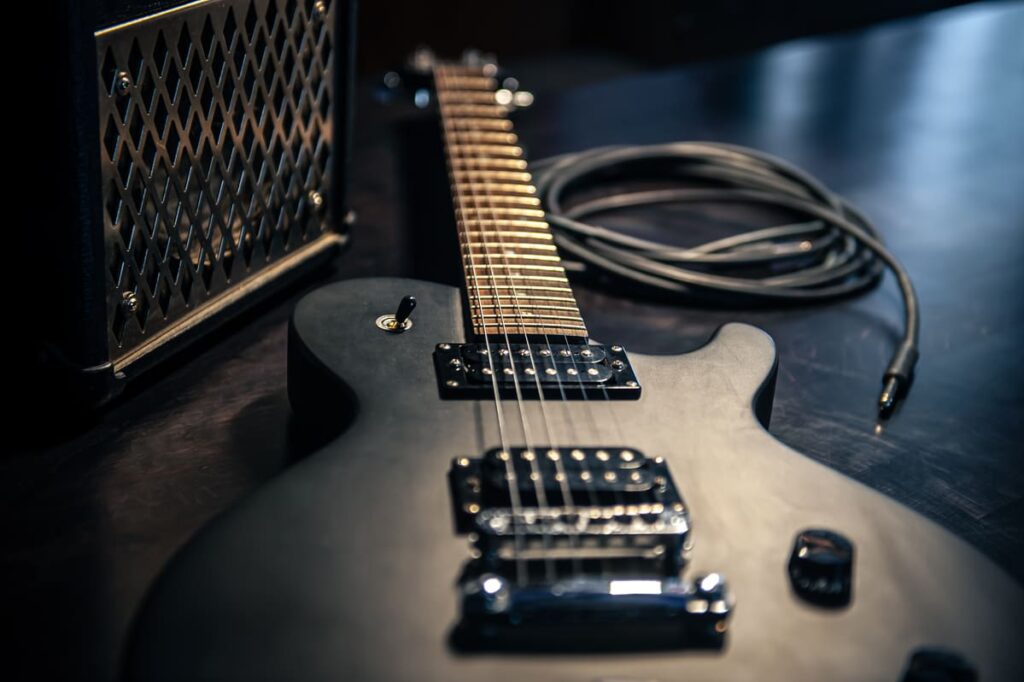 A black electric guitar on a table