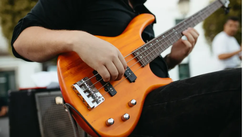 A person playing a bass guitar