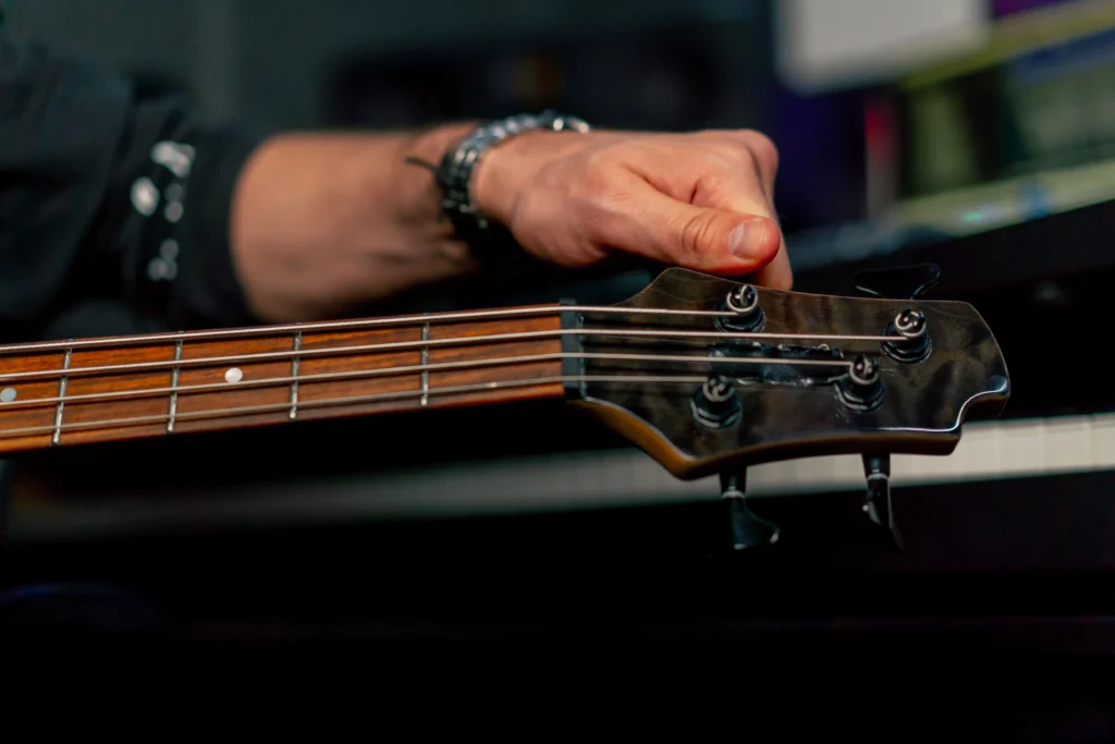 A person tuning the bass guitar